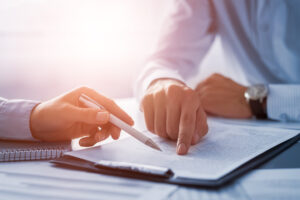 First-time home buyer reviewing home purchase documents with a real estate agent in Canada