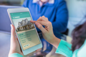 Homebuyer viewing a house listing on a tablet