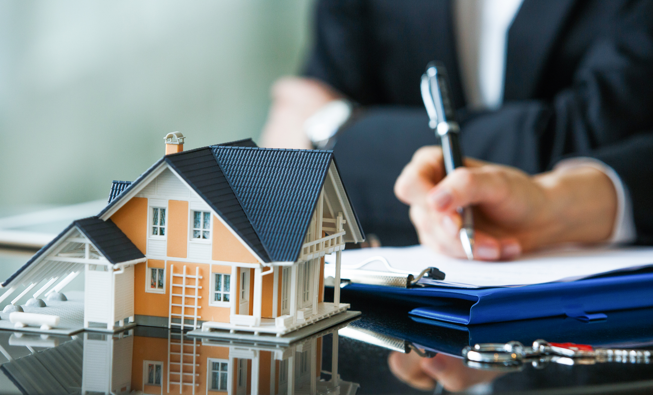 Real estate professional analyzing a home's value and pricing