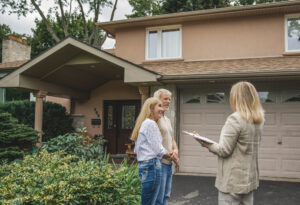 Homeowners discussing a property outside a house